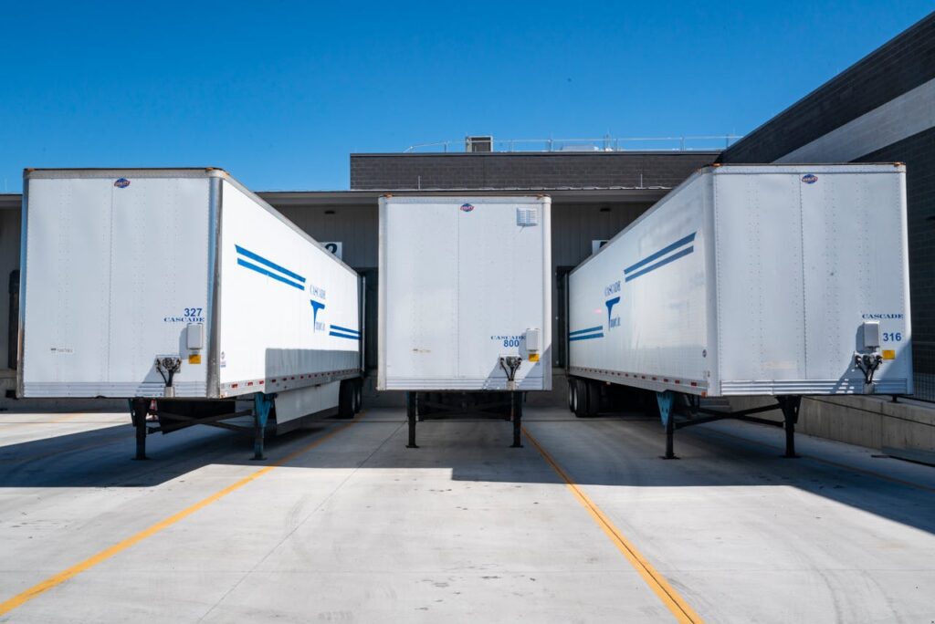 Trailers parked in the bay of a warehouse.